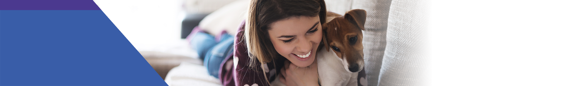 Woman on her bed snuggling a dog